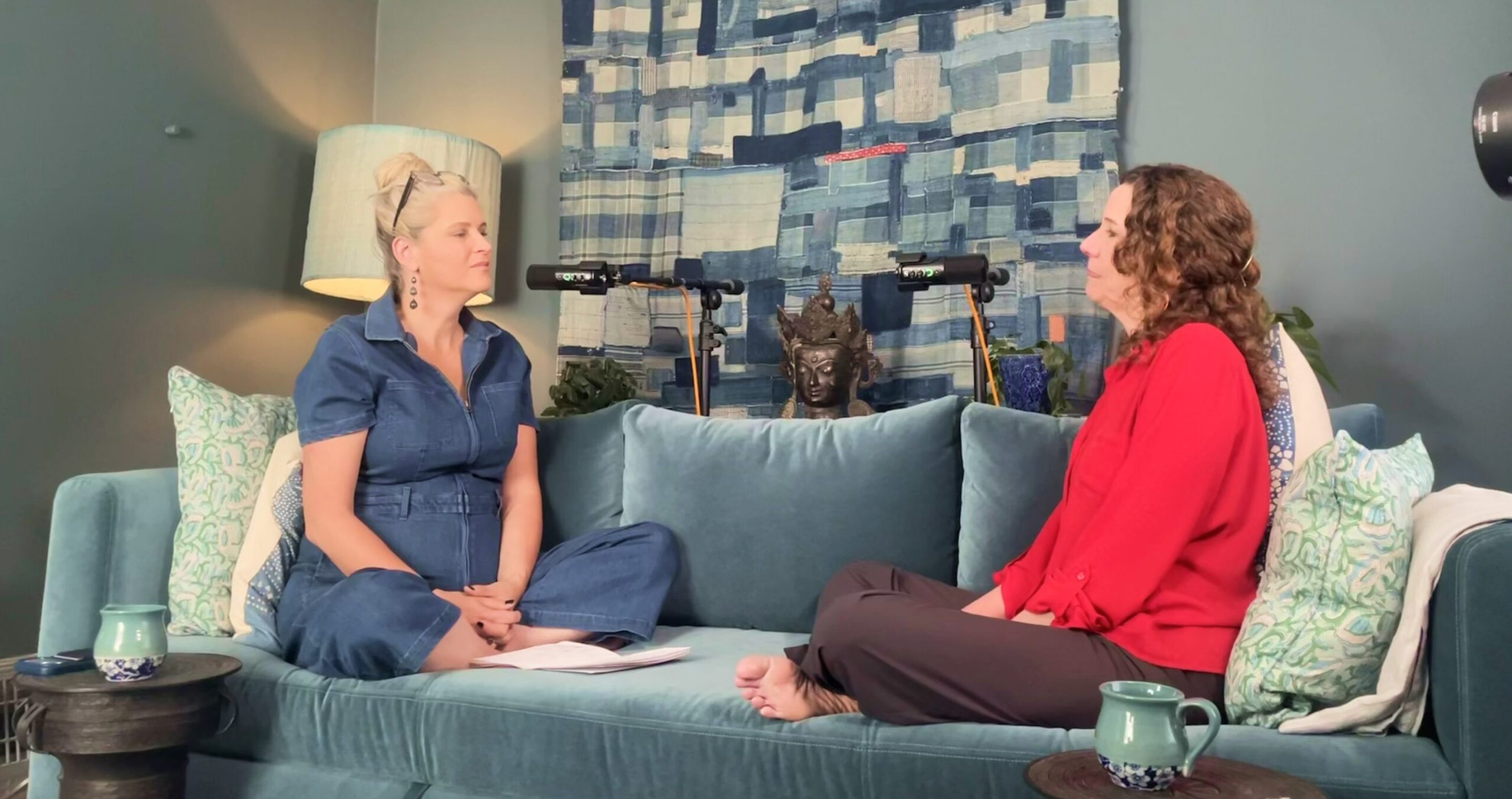 Lisa Shannon and a guest seated on a teal sofa during a Benefit of Beings conversation